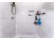Close up of shower featuring white marble tile, and built in shelving for bathroom products at 2990 Carnelian St, Las Vegas, NV 89121