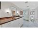 Well-lit bathroom with a floating vanity, large mirror, and walk-in shower with glass enclosure at 3111 Bel Air Dr # 7D, Las Vegas, NV 89109