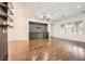 Bright and airy living room featuring hardwood floors, modern lighting, and custom shelving at 3198 Stella Cilento Ave, Henderson, NV 89044