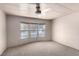 Bright carpeted bedroom with three windows and a neutral color palette at 3471 Cape Cod Dr, Las Vegas, NV 89122
