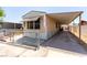 Exterior view showing a home with a covered parking area and fenced front at 3471 Cape Cod Dr, Las Vegas, NV 89122