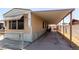 Home with a long, covered parking area, secured by a chain-link fence at 3471 Cape Cod Dr, Las Vegas, NV 89122