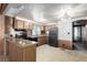 Well-lit kitchen showcasing black appliances, light wood cabinets, and stone countertops at 3471 Cape Cod Dr, Las Vegas, NV 89122