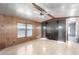 Cozy living room space with light wood-look floors, feature wall, and large windows at 3471 Cape Cod Dr, Las Vegas, NV 89122