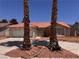Home featuring an orange tile roof, desert landscaping, and mature palm trees at 3644 Valley Dr, North Las Vegas, NV 89032