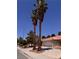 Nice home featuring an orange tile roof, two tall palm trees, and desert landscaping at 3644 Valley Dr, North Las Vegas, NV 89032