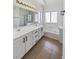 Well-lit bathroom with double sinks, modern cabinets, and a shower-tub combination at 3804 Wren Ct, North Las Vegas, NV 89032