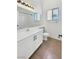 Bright bathroom featuring a vanity, large mirror, and tile flooring at 3804 Wren Ct, North Las Vegas, NV 89032