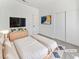 Modern bedroom with minimalist decor, a large bed, and a sliding-door closet at 3804 Wren Ct, North Las Vegas, NV 89032