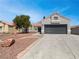 Charming single-story home featuring a two-car garage and low-maintenance desert landscaping at 3804 Wren Ct, North Las Vegas, NV 89032