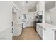 Modern kitchen features white cabinets, countertops, stainless steel appliances and black hardware at 3804 Wren Ct, North Las Vegas, NV 89032
