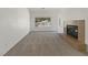 Living room featuring a fireplace, carpeted flooring, and natural lighting at 3804 Wren Ct, North Las Vegas, NV 89032