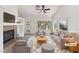 Bright living room with a fireplace, large windows, neutral decor, and ample seating at 3804 Wren Ct, North Las Vegas, NV 89032