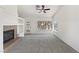 Bright living room with a fireplace, large windows, and neutral carpet and paint at 3804 Wren Ct, North Las Vegas, NV 89032