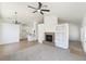 Open-concept living room with a fireplace, ceiling fan, and access to the kitchen at 3804 Wren Ct, North Las Vegas, NV 89032