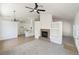 Open-concept living room with a fireplace, ceiling fan, and access to the kitchen at 3804 Wren Ct, North Las Vegas, NV 89032
