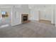 Open-concept living room featuring a fireplace, carpeted flooring, and natural lighting at 3804 Wren Ct, North Las Vegas, NV 89032