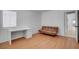 Bedroom features wood-look floors, a desk, and a futon sofa at 406 River Glider Ave, North Las Vegas, NV 89084