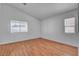Bright bedroom featuring wood-look flooring and natural light from the windows at 406 River Glider Ave, North Las Vegas, NV 89084