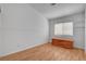 Bright bedroom with wood floors and a storage chest under the window at 406 River Glider Ave, North Las Vegas, NV 89084
