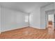 Neutral bedroom with hardwood floors and large window for natural light at 406 River Glider Ave, North Las Vegas, NV 89084