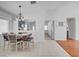 Open-concept dining area with tile flooring, neutral walls, and seamless connection to the kitchen at 406 River Glider Ave, North Las Vegas, NV 89084