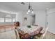 Bright dining space with tile floors, modern lighting, and seamless flow to the adjacent living areas at 406 River Glider Ave, North Las Vegas, NV 89084