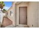 Close up of the front door and walkway with low maintenance landscaping and neutral paint scheme at 406 River Glider Ave, North Las Vegas, NV 89084