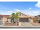 Charming single story home featuring a two car garage and low maintenance desert landscaping at 406 River Glider Ave, North Las Vegas, NV 89084