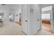 Hallway with tile flooring connects rooms and includes a wood storage chest at 406 River Glider Ave, North Las Vegas, NV 89084