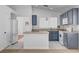 Modern kitchen with island, white appliances and backsplash, and ample storage at 406 River Glider Ave, North Las Vegas, NV 89084