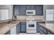 Close-up of modern kitchen with gas range, updated backsplash, and ample counter space at 406 River Glider Ave, North Las Vegas, NV 89084