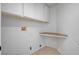 Laundry room featuring white cabinets and a built-in shelf at 406 River Glider Ave, North Las Vegas, NV 89084