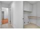 Laundry room features white cabinets and a built-in shelf at 406 River Glider Ave, North Las Vegas, NV 89084