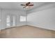 Bright living room with tile floors, ceiling fan, and access to the backyard at 406 River Glider Ave, North Las Vegas, NV 89084