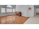 Bright and airy living room with hardwood floors and large windows, perfect for relaxation or entertaining at 406 River Glider Ave, North Las Vegas, NV 89084
