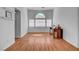 Sunlit living room boasts hardwood floors, large windows, and neutral walls for a welcoming atmosphere at 406 River Glider Ave, North Las Vegas, NV 89084