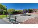 Community playground featuring colorful play structures, benches, and a walking path for Gathering enjoyment at 406 River Glider Ave, North Las Vegas, NV 89084