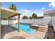 Relaxing backyard featuring a private pool and spa with a covered patio, perfect for outdoor entertainment at 406 River Glider Ave, North Las Vegas, NV 89084