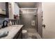 This bathroom features a marble countertop, white cabinets, and shower with sliding glass doors at 4129 Ridgewood Ave, Las Vegas, NV 89120