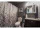 Cozy bathroom with neutral tones, a vanity with a dark finish, and a shower with a decorative curtain at 4129 Ridgewood Ave, Las Vegas, NV 89120