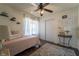 Cozy bedroom with ceiling fan, hardwood floors, and a decorative 'Home' wall hanging at 4129 Ridgewood Ave, Las Vegas, NV 89120