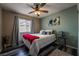 Comfortable bedroom with stylish ceiling fan, plank floors, and a bright red throw at 4129 Ridgewood Ave, Las Vegas, NV 89120