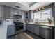 Modern kitchen with stainless steel appliances, gray cabinetry, and stylish backsplash at 4129 Ridgewood Ave, Las Vegas, NV 89120