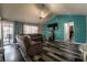 Comfortable living room with vaulted ceiling, ample seating, and a large TV for entertainment at 4129 Ridgewood Ave, Las Vegas, NV 89120