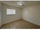 Bedroom featuring light-colored walls, tile flooring and a window with blinds at 4200 Via Vaquero Ave, Las Vegas, NV 89102