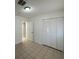 Bedroom featuring a ceiling fan, tile flooring and closet with sliding doors at 4200 Via Vaquero Ave, Las Vegas, NV 89102