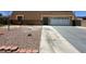 Modest home featuring a two-car garage, desert landscaping, and a long driveway at 4200 Via Vaquero Ave, Las Vegas, NV 89102