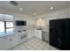 Bright kitchen with stainless steel appliances, white cabinets, and tile flooring at 4200 Via Vaquero Ave, Las Vegas, NV 89102
