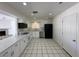 Updated kitchen with stainless steel appliances, white cabinets, and a view to the living room at 4200 Via Vaquero Ave, Las Vegas, NV 89102